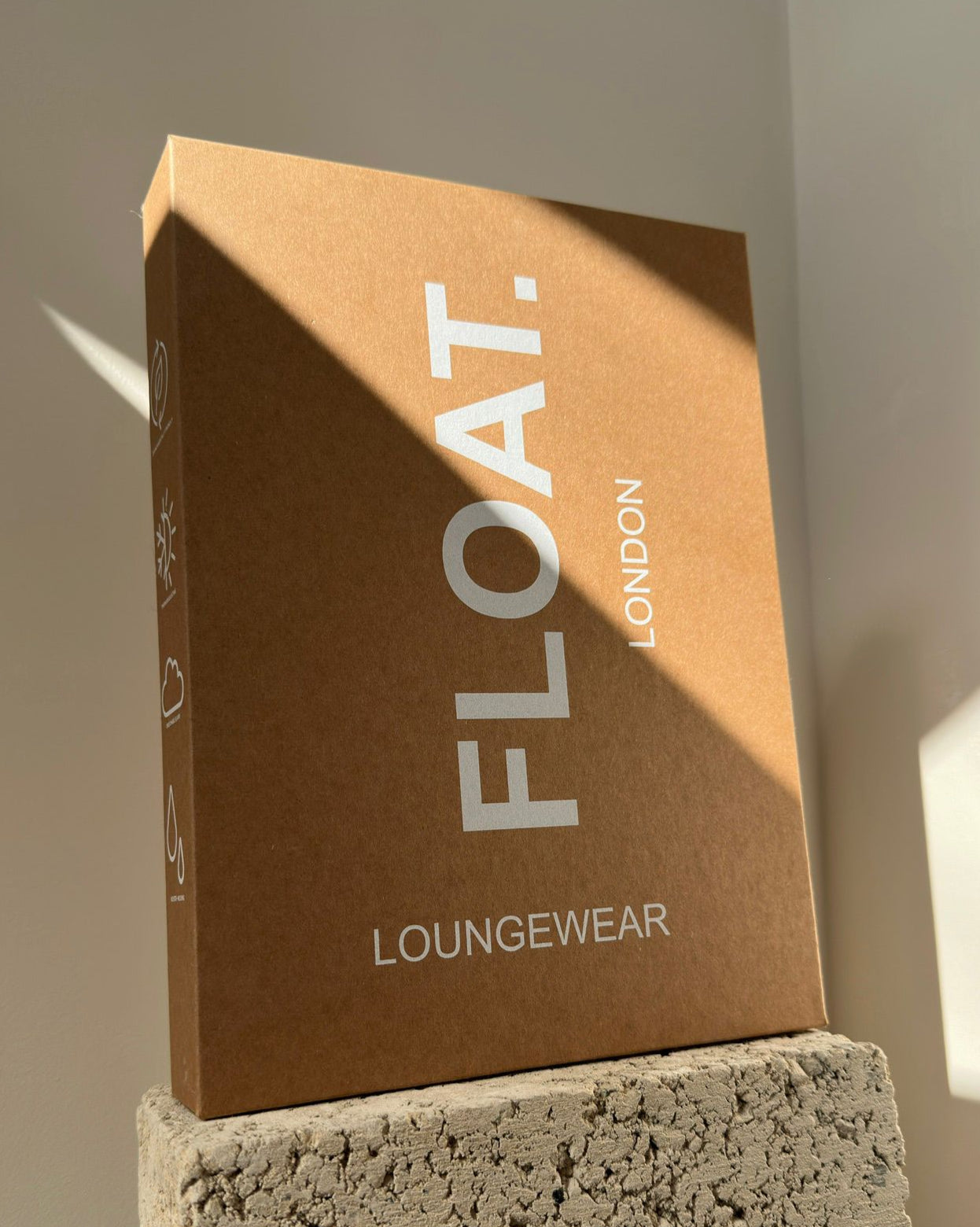 Brown box with 'FLOAT. LONDON' branding on a textured surface